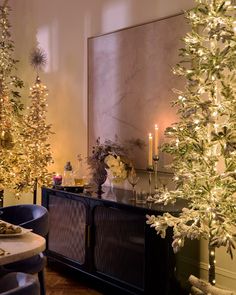 christmas trees are lit up in the dining room