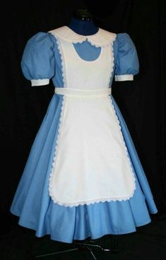 a blue and white dress on display in front of a black background with the collared neckline down