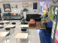 an empty classroom with desks and chairs in front of the chalkboard wall that has pictures on it