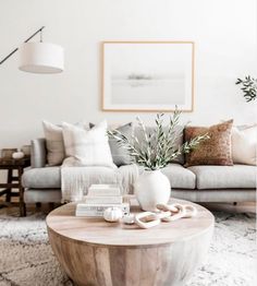 a living room filled with lots of furniture and decor on top of a white rug