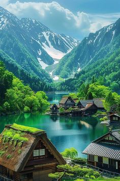 the mountains are covered with snow and green trees, while houses sit in front of a body of water