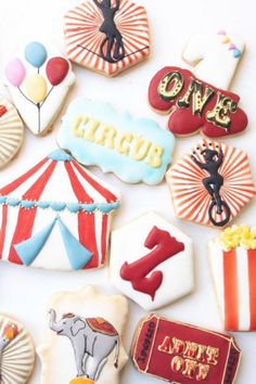 circus themed cookies are arranged on a white surface