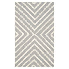 a gray and white rug with diagonal stripes