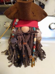 a pirate doll with dreadlocks and a hat