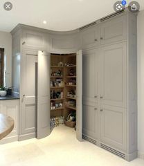 an open closet in the middle of a room with a sink and countertop area