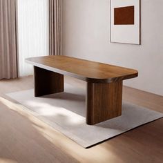 a wooden table sitting on top of a white rug in front of a large window