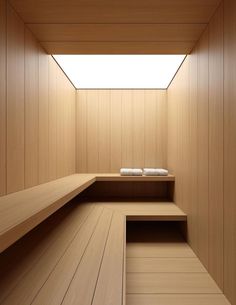 an empty sauna with wooden walls and benches