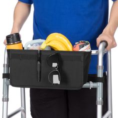 a man is holding a walker with a basket full of food and drinks in it