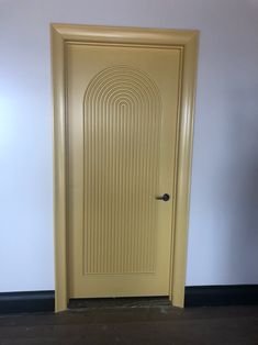 a yellow door in an empty room