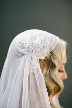 a woman wearing a veil with flowers on it