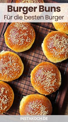 some buns are on a cooling rack with sesame sprinkled on top and the words, burger buns fur die besten burger