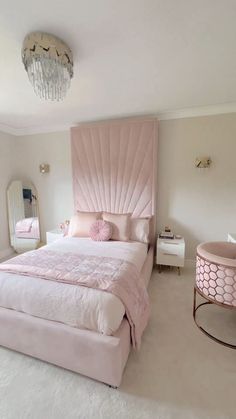 a bedroom with a large pink bed in it