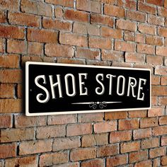 there is a sign that says shoe store on the wall next to a brick wall