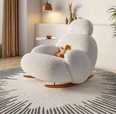 a white chair sitting on top of a rug in a living room