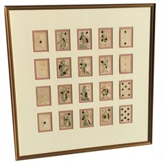 a framed art work with playing cards on it