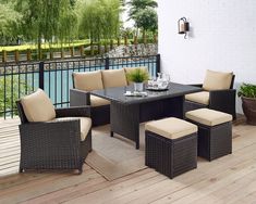 an outdoor table and chairs on a deck