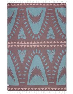 a blue and brown area rug with an abstract design on the front, in various colors