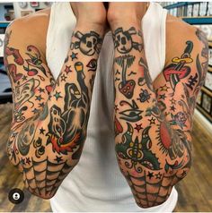 a man with many tattoos covering his hands