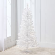 a small white christmas tree in a room