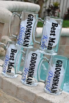 six glass mugs sitting next to each other in front of a swimming pool with the words groom and best man on them