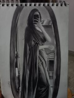 a pencil drawing of a woman holding a mirror