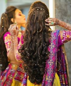 two women with long hair are looking at each other