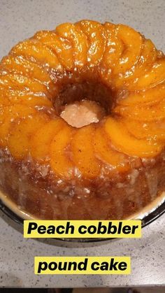 there is a cake with peach cobbler topping on the top, and an upside down pound cake below