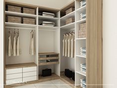 an organized closet with white drawers and clothes hanging on the shelves, along with baskets