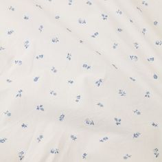 a white sheet with blue flowers on it