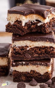 three pieces of cake sitting on top of each other with chocolate chips around them and one slice cut in half