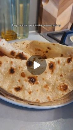 two pita breads sitting on top of a white plate