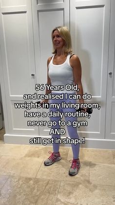 a woman in white tank top and purple leggings standing next to closet doors