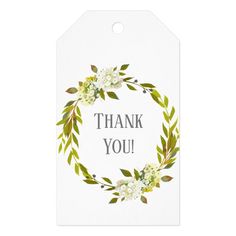 a white thank tag with flowers and leaves on the front that says, thank you