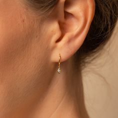 D A N G L E ∙ H U G G I E ∙ H O O P S Add some geometric spice to your earring stack with our Dangling Huggie Hoops. The diamond shaped dangling earring charm sparkles with a diamond stone nestled perfectly inside. Elegant and easy to wear, these earrings will fit into any ensemble. * Material: High Quality Solid 925 Sterling Silver  * Finish: Sterling Silver ∙ 18K Gold  * Featuring ~8.5mm Inner Diameter | ~11mm Outer Diameter | ~18mm Total Earring Length with a CZ Dangling Charm * Sold as a pai Huggies Earrings Silver, Dainty Diamond Earrings, Pave Heart Necklace, Earring Charm, Earring Stack, Diamond Huggies, Heart Locket Necklace, Dangle Hoop Earrings, H U