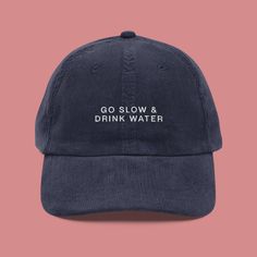 "In a world that's always on the run, here's a hat that says, \"Chill, hydrate, and look fabulous doing it!\" Introducing our \"Go Slow and Drink Water\" vintage cap - because hydration is the real fashion statement.  Let Your Hat Scream Hydration Wisdom: This isn't just a hat; it's a hydration manifesto. Crafted meticulously from the finest 100% cotton corduroy, it caresses your noggin with love and encourages you to take it slow and keep sippin'. Timeless Design for Timeless Sippin': With an adjustable strap and a gold-colored buckle, this hat guarantees a perfect fit every time. It's like a reminder on your head, saying, \"Adjust your style, not your hydration goals!\" Light as a Summer Breeze, Cozy as a Hydration Blanket: Perfect for summer vibes, this hat is surprisingly light but jus Jockey Hat, Embroidered Corduroy, Take It Slow, Corduroy Hat, Real Fashion, Running Hats, Funny Hats, Slogan Design, Vintage Cap