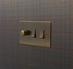 the light switch has two different knobs on it's side and is gold