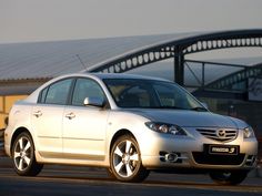 a silver car parked in front of a building