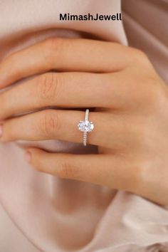 a woman's hand with a diamond ring on her finger and the words miash jewel