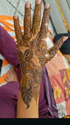 a woman's hand with henna on it