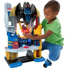 a young boy playing with a toy set