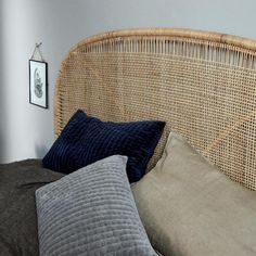 a wicker headboard with two pillows on it