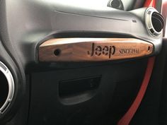 the interior of a car with an emblem on it's dash board and door handle