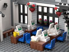 there is a lego restaurant with tables and chairs in front of the building's windows