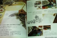 an open book with pictures of mountains and other things on the pages, including watercolors