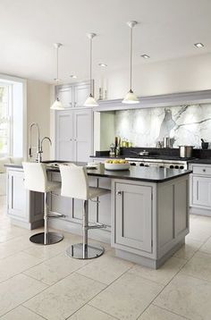 a large kitchen with an island in the middle