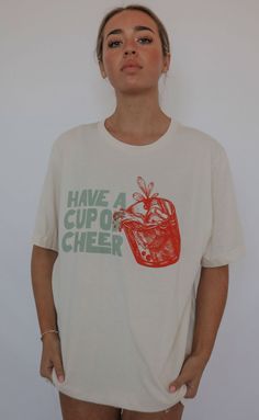 Have a cup of cheer! We love the vintage, festive feel that this shirt gives. It’s classic and timeless but still fun, which is what Christmas fashion is all about. Throw this shirt on to host your holiday parties and let people know you’re a good time from the moment they walk in your house. Lili is 5'7" and is wearing size medium Mary Claire is 5'8" and is wearing size medium sizing guide: small: 36” bust | 28” length medium: 39" bust and 28.5" length large: 42” bust | 30” length extra large: Christmas T-shirts, Have A Cup Of Cheer, Cup Of Cheer, Cheer Tshirts, What Is Christmas, Re A, Christmas Fashion, Good Time, Dress Romper