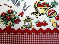 the table cloth has an image of fruits and vegetables on it, along with utensils