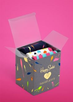 a box with some kind of cake inside of it on a pink background and the words happy birthday