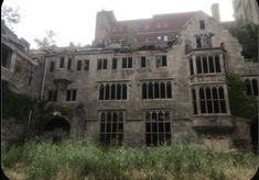 an old building with lots of windows and ivy growing on it