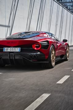 a red sports car driving down the road